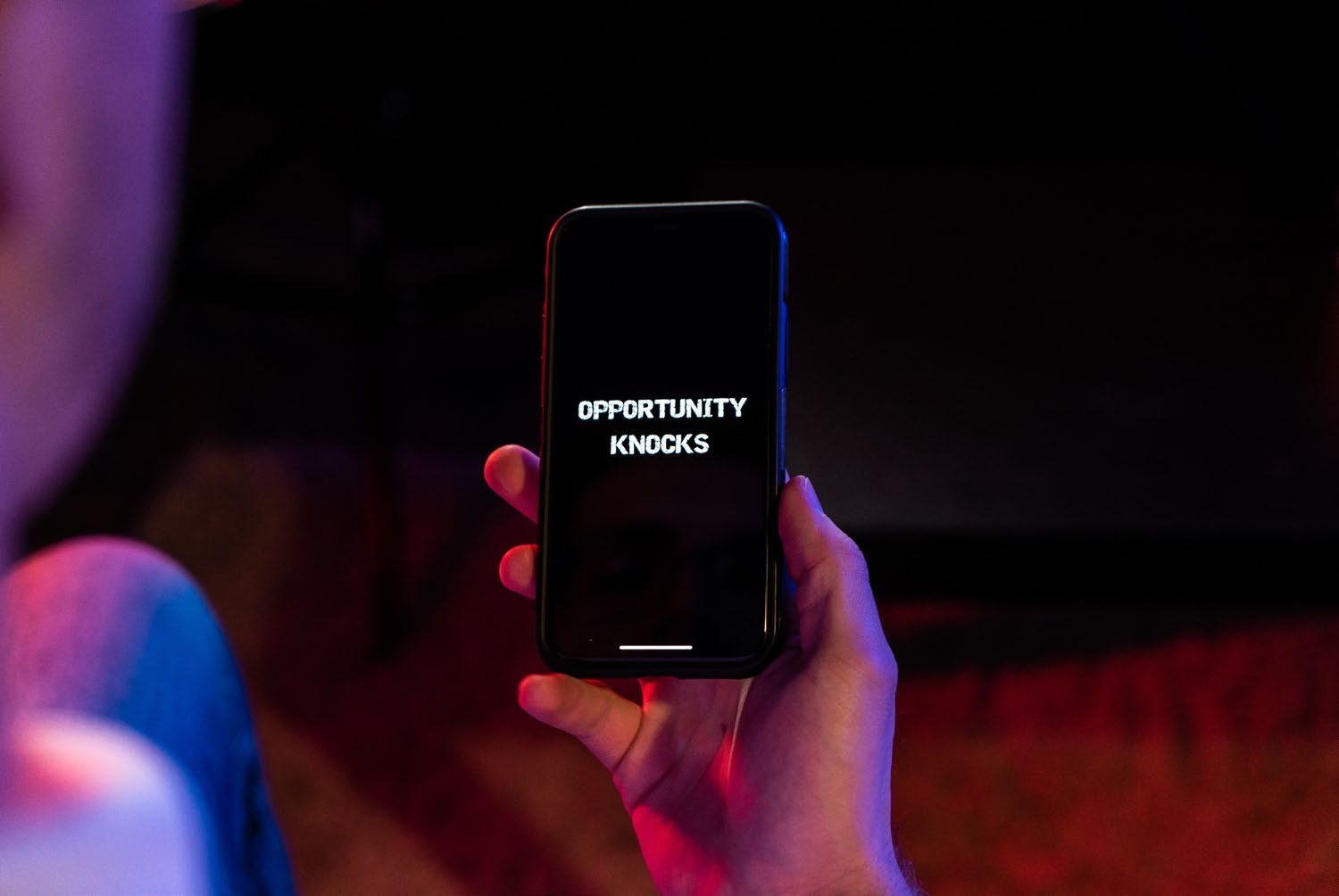 A phone which has the words opportunity knocks on its screen