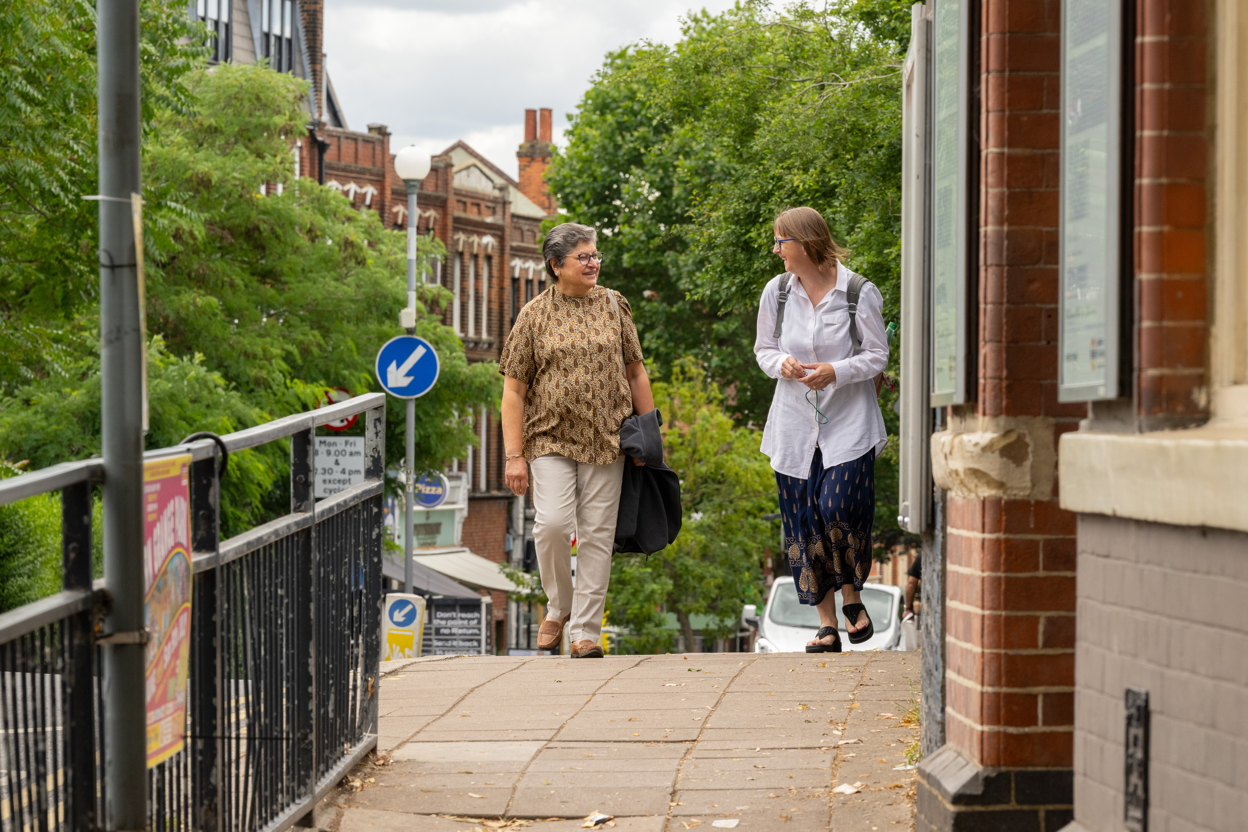 Prati and Sylvie walking to their local overground station.