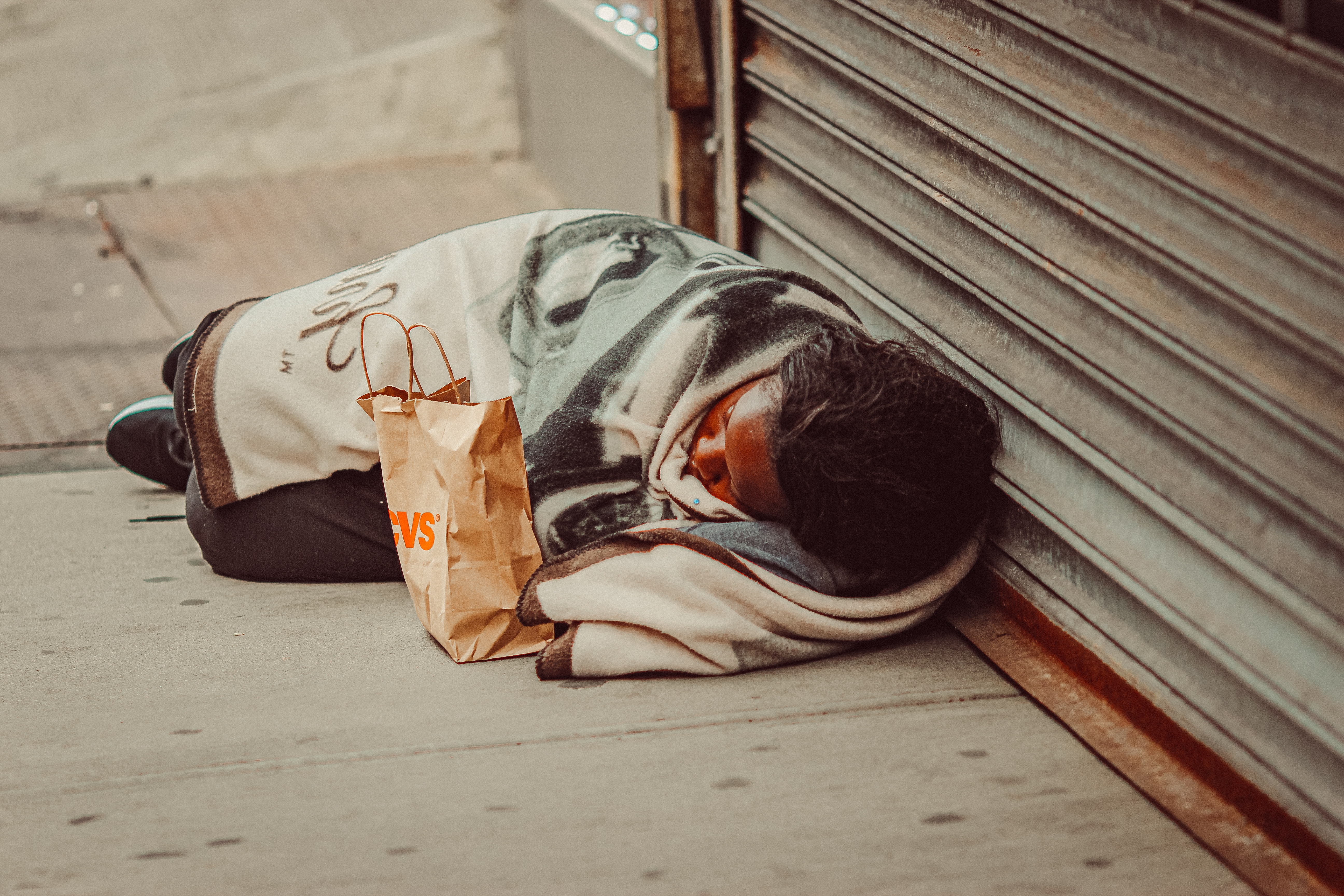 Homeless woman lying on the street