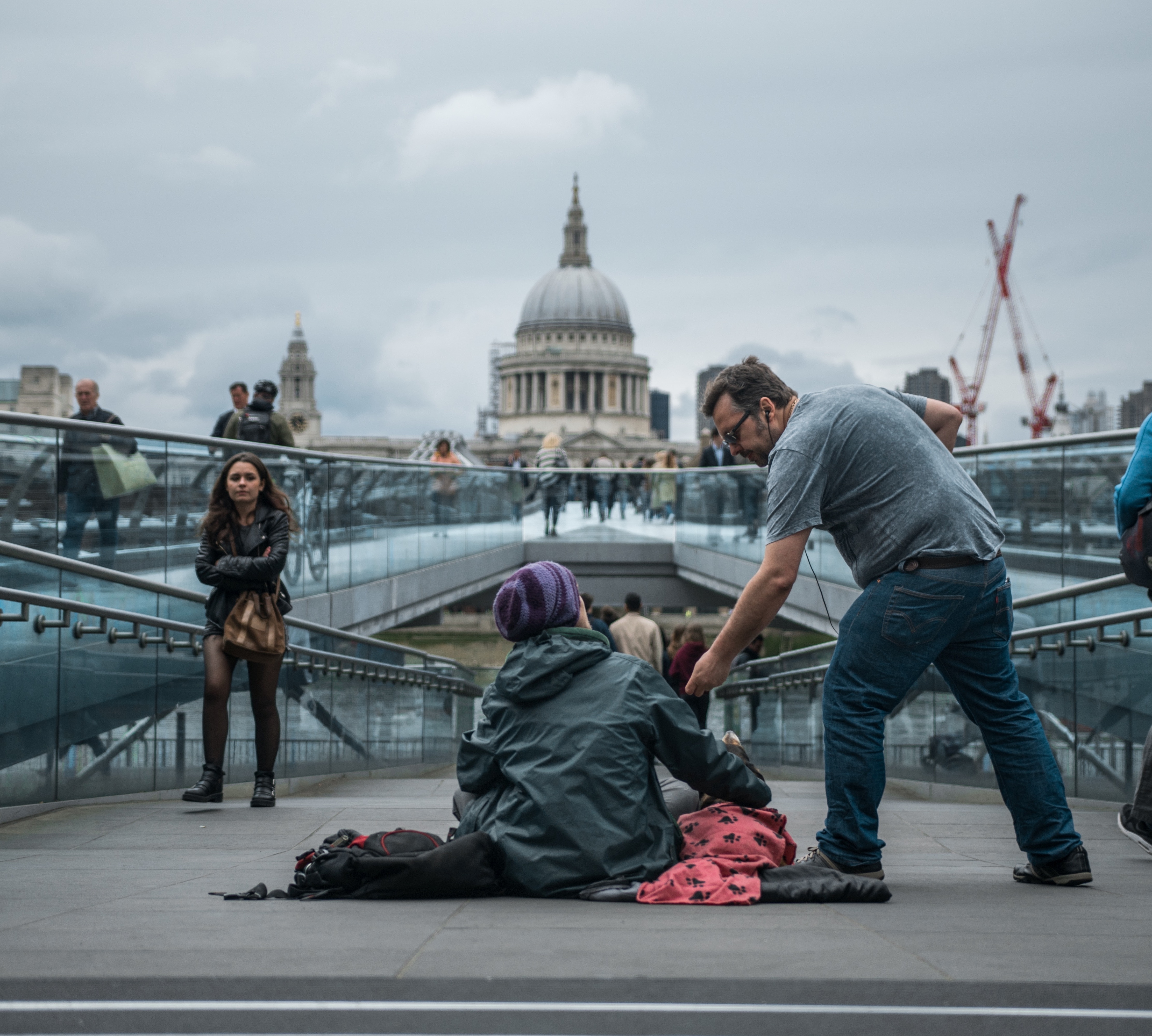 Man giving homeless man money