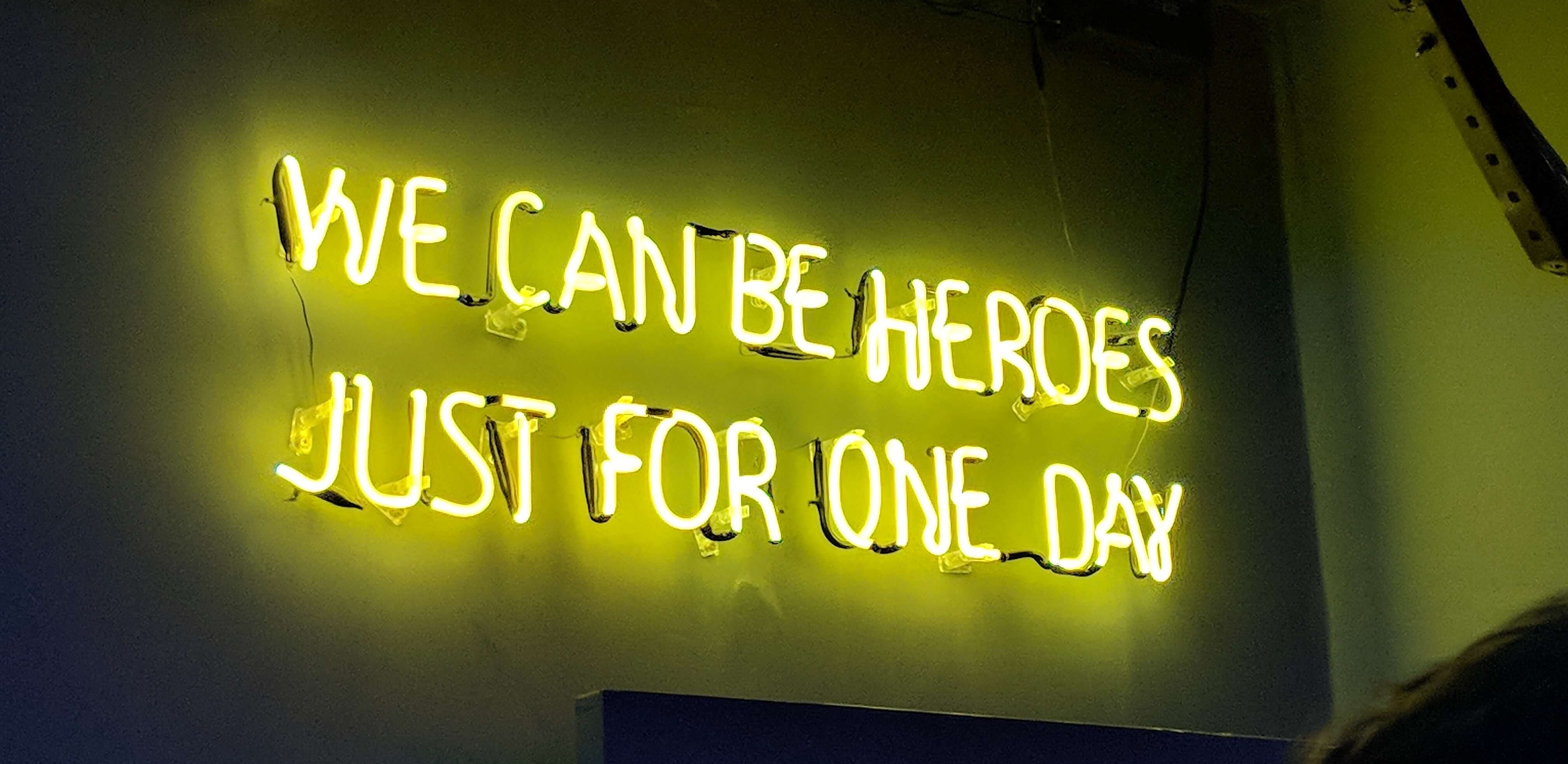Neon sign saying We can be heroes just for one day