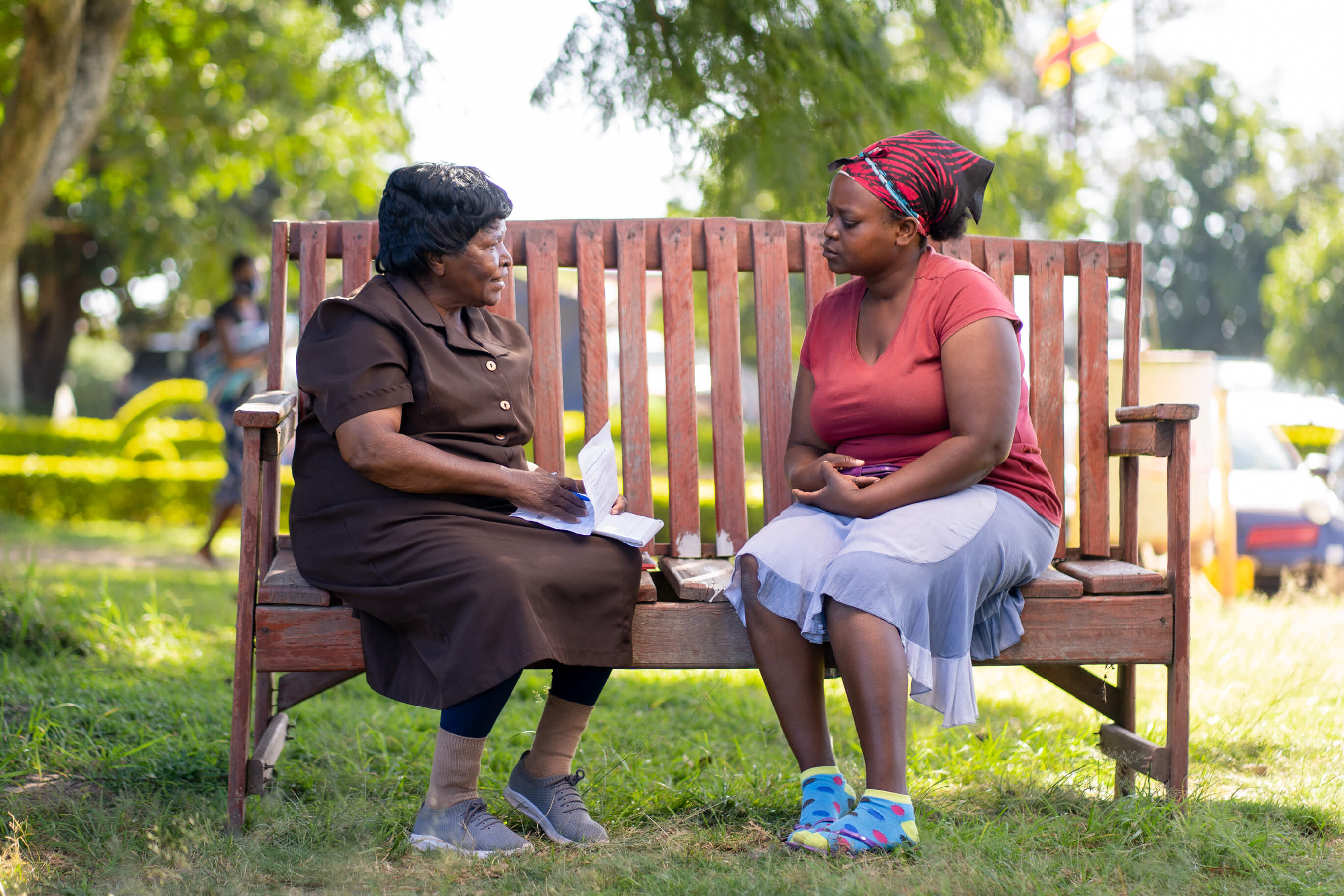 An older woman and younger woman on a bench