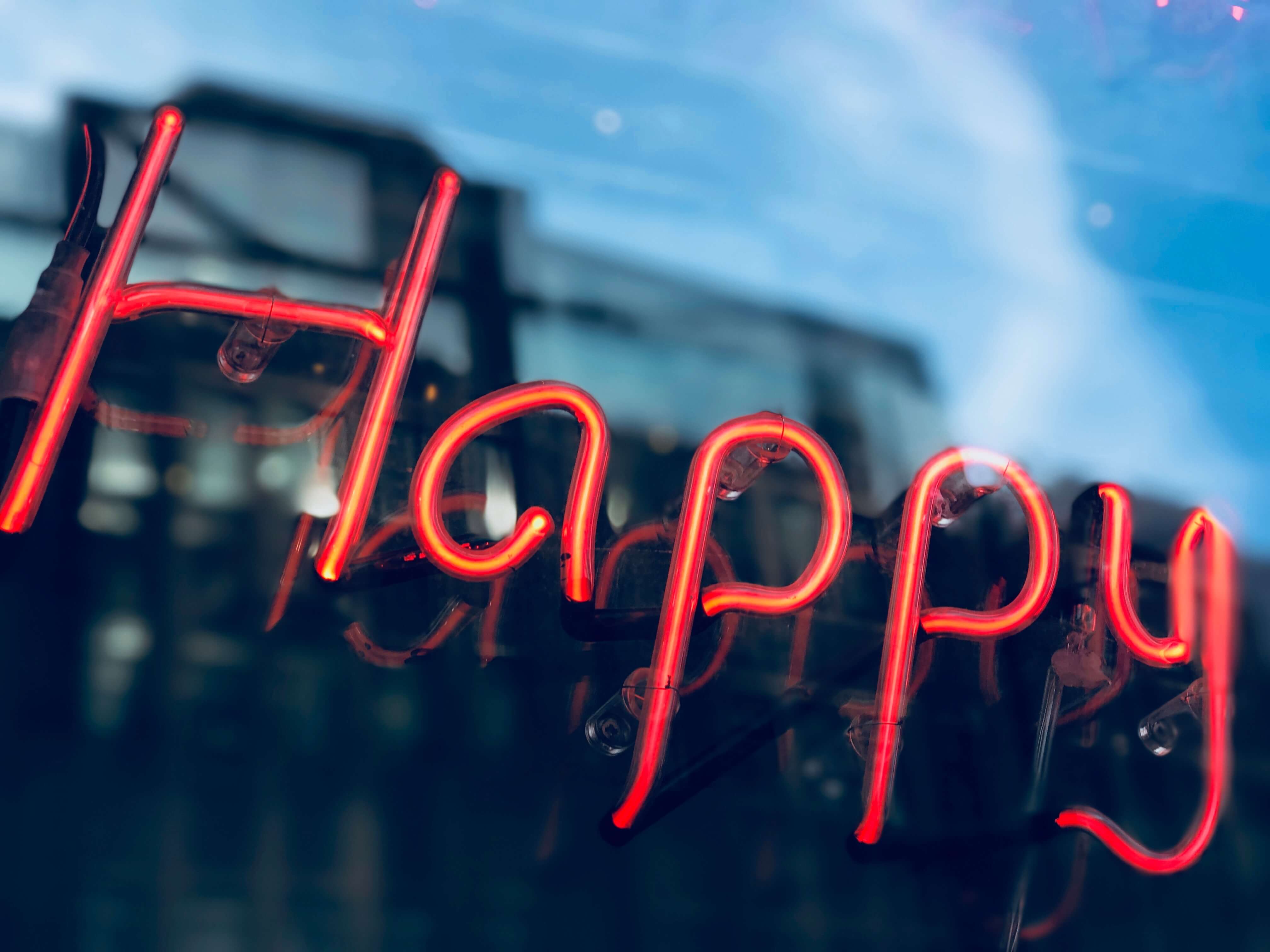 A neon sign saying happy