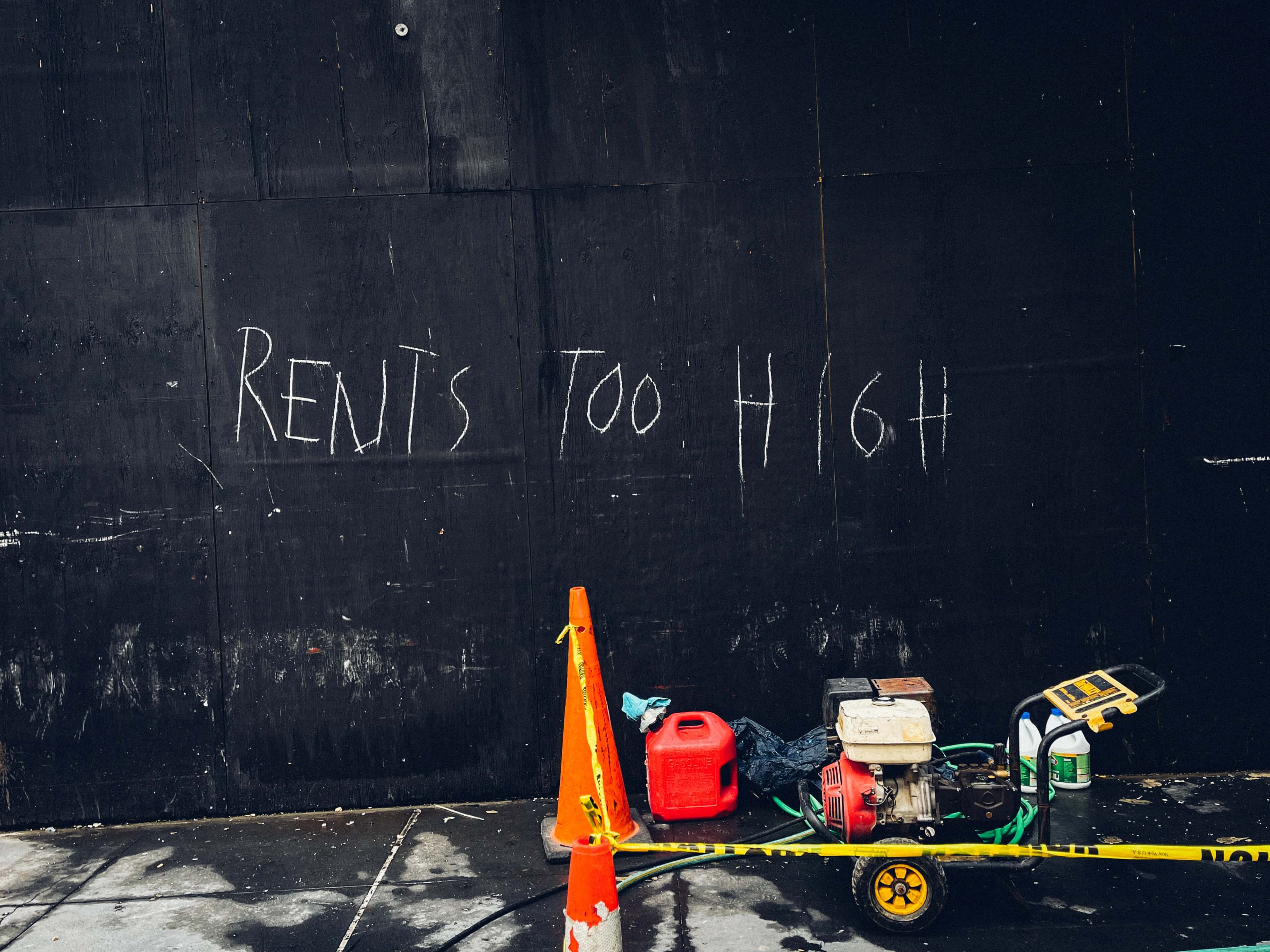 Rents too high written on a blackboard