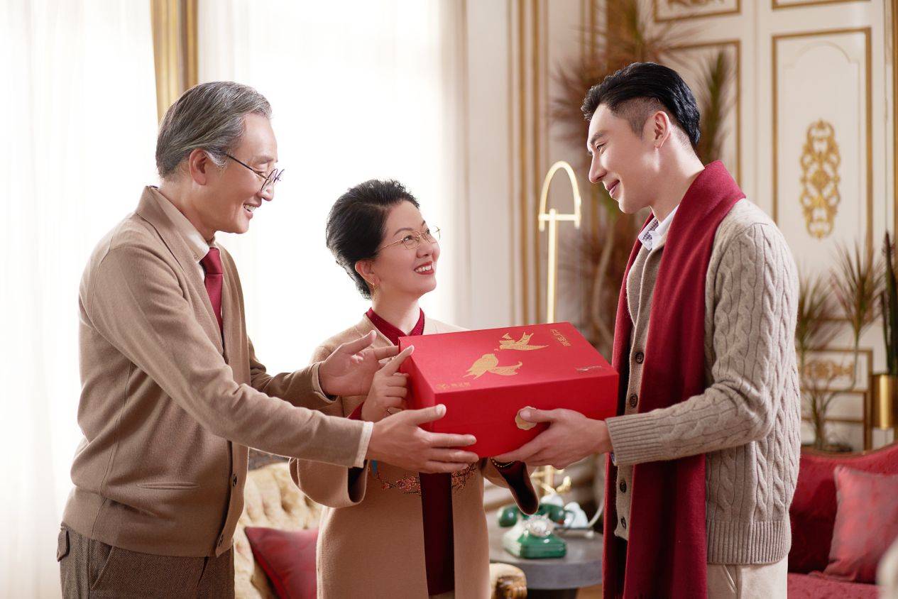 A Chinese young man giving a gift of ginseng to his parents