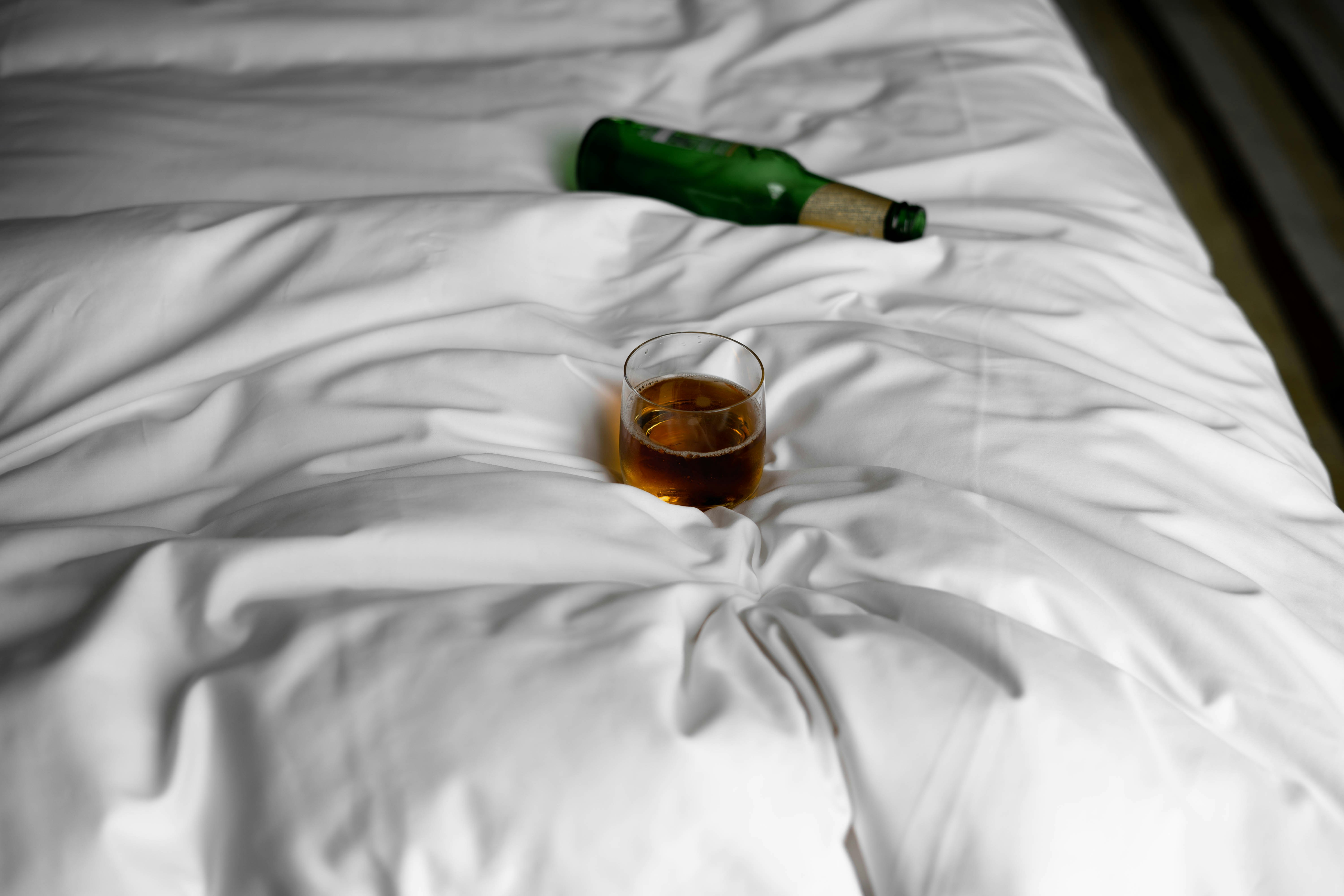 bottle of lager on a bed