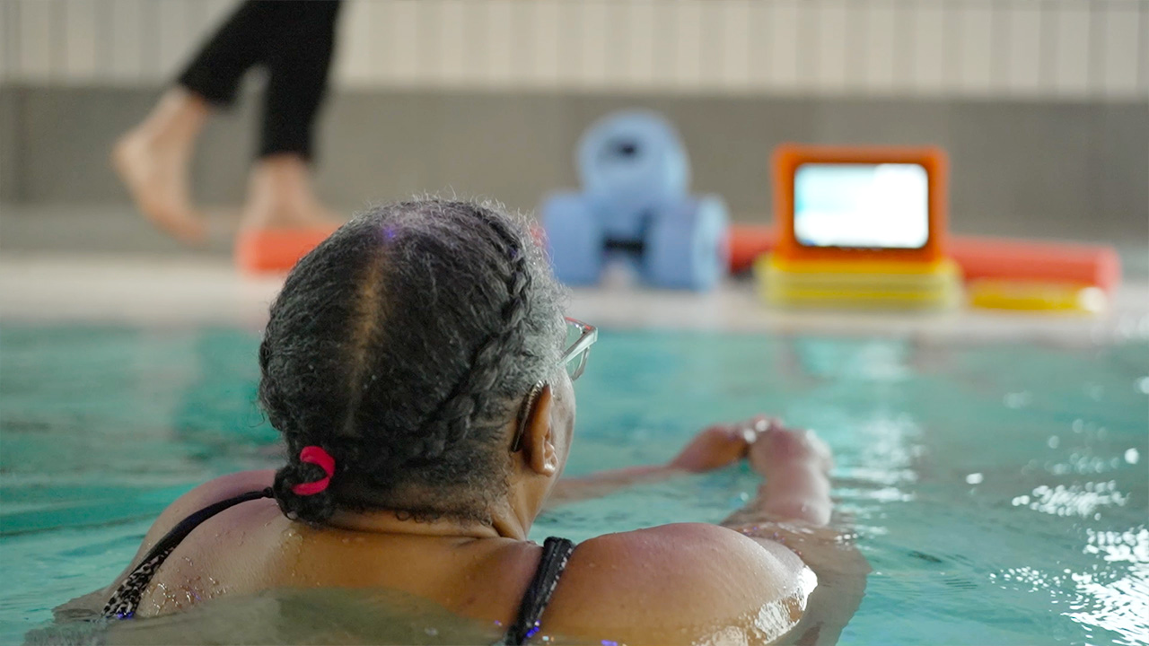 Woman using the Good Boost tablet in a pool