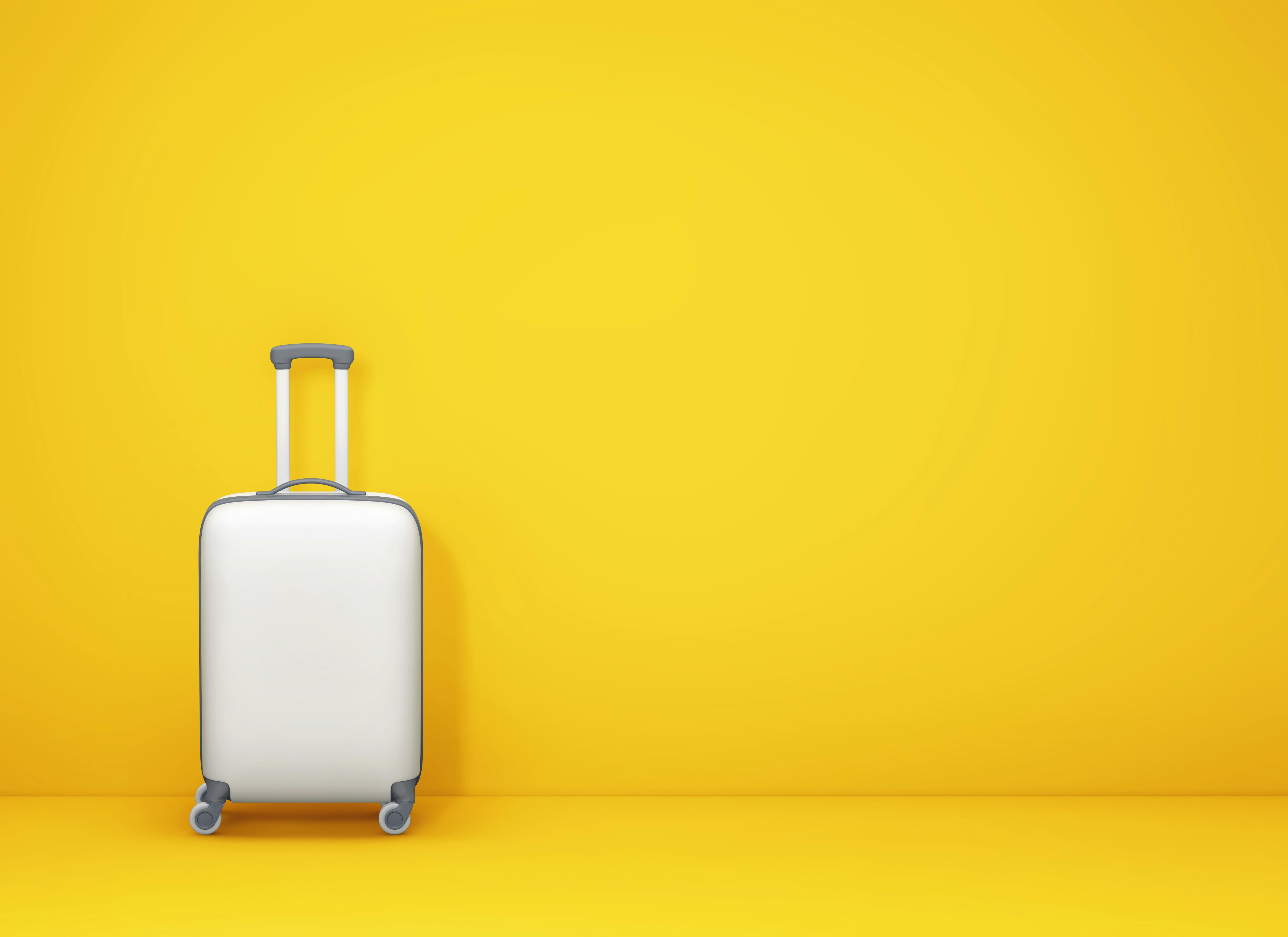 Suitcase with yellow backdrop