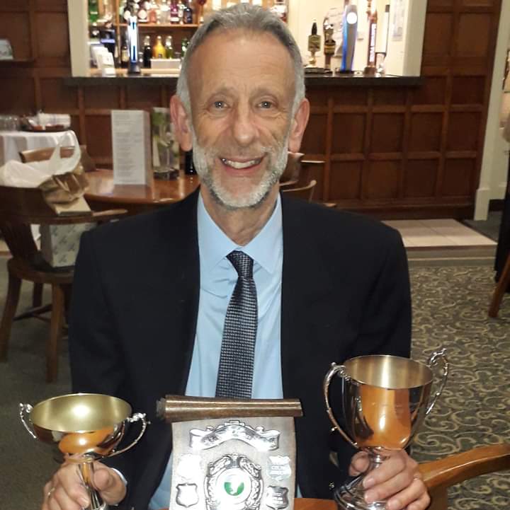 Mike at the croquet annual dinner with his trophies