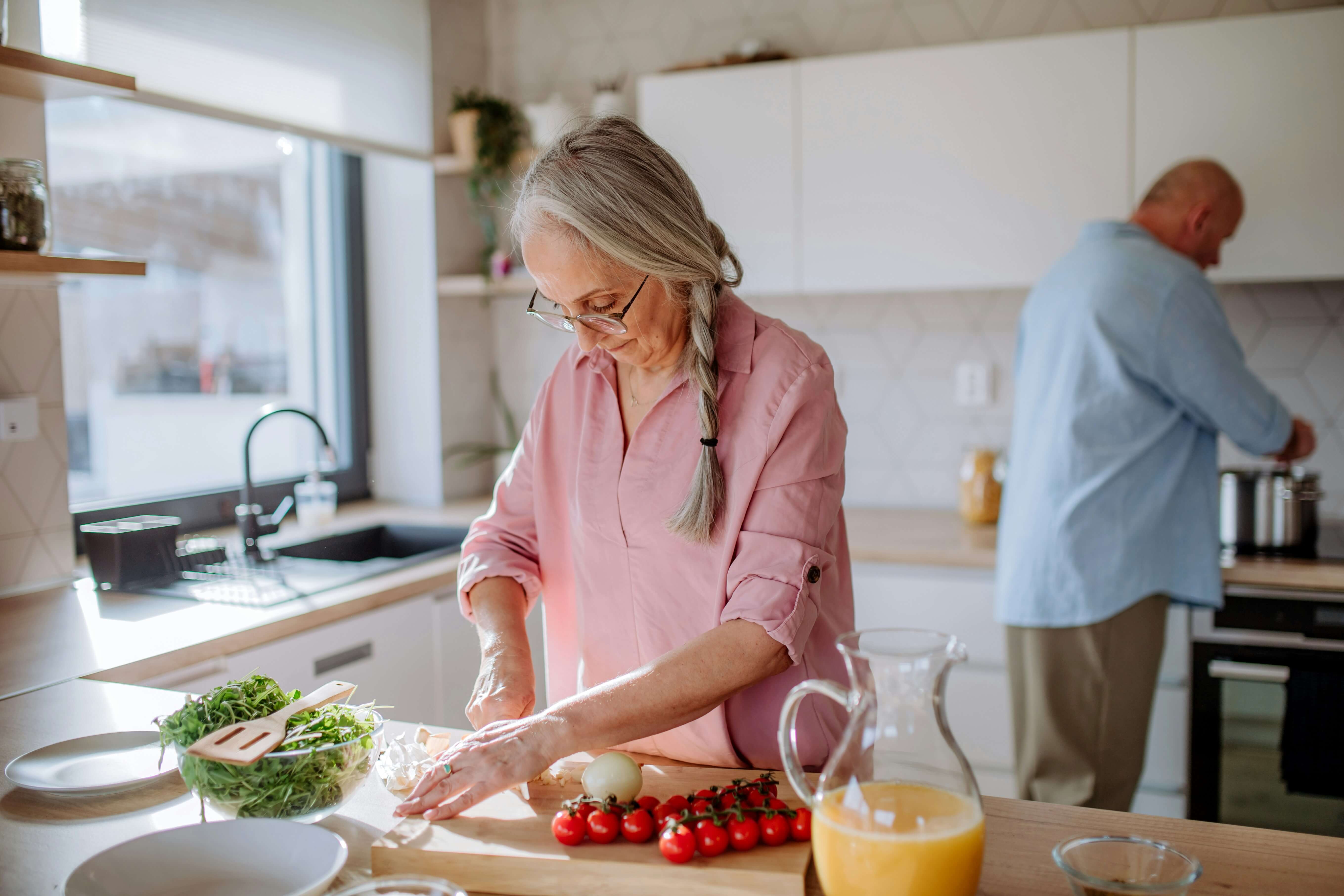 Older woman cooking healthy food