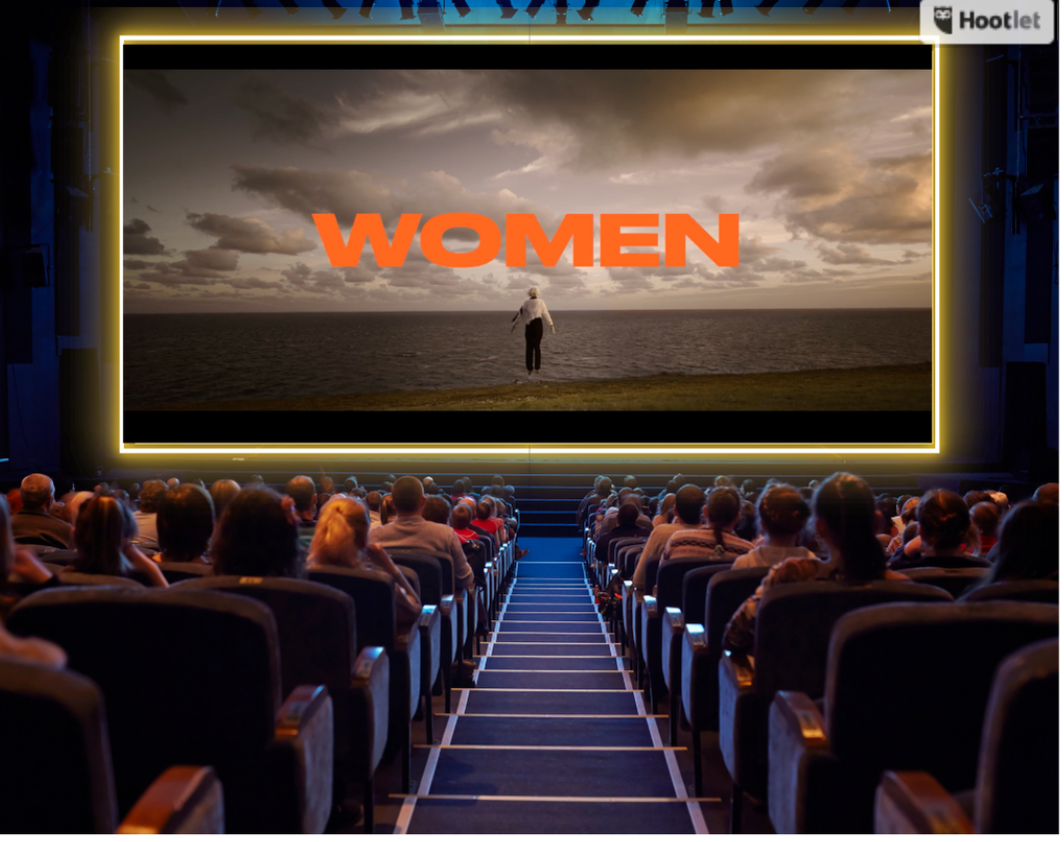 Women in a cinema watching a screen which says women