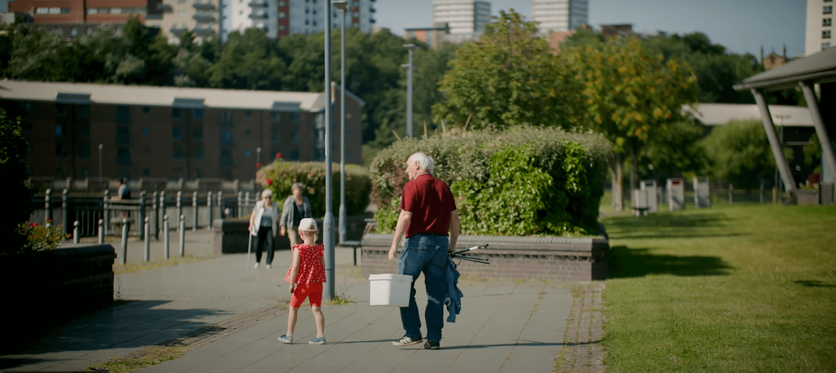 Older fisherman with young granddaugter.