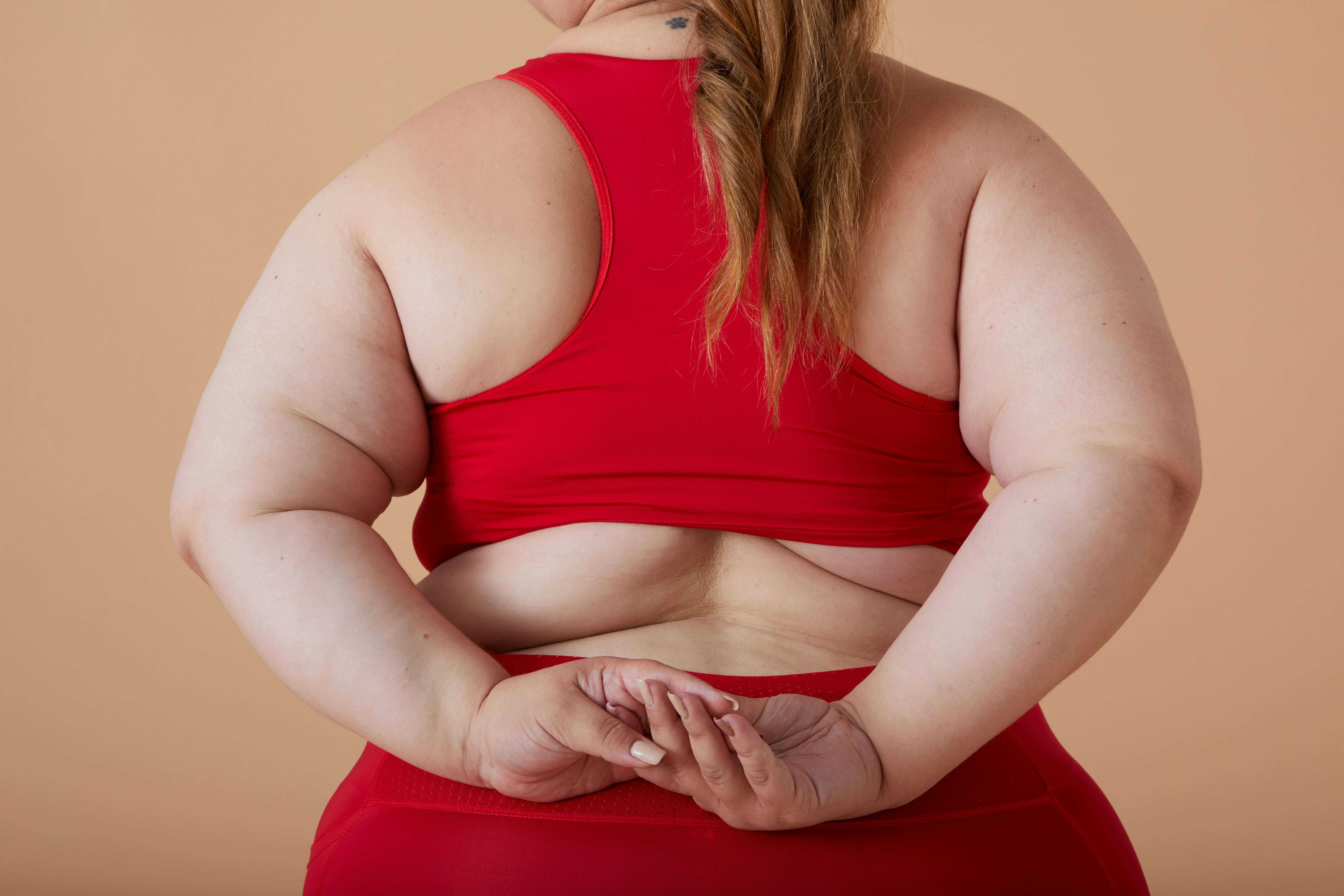 Overweight woman wearing red gym clothes