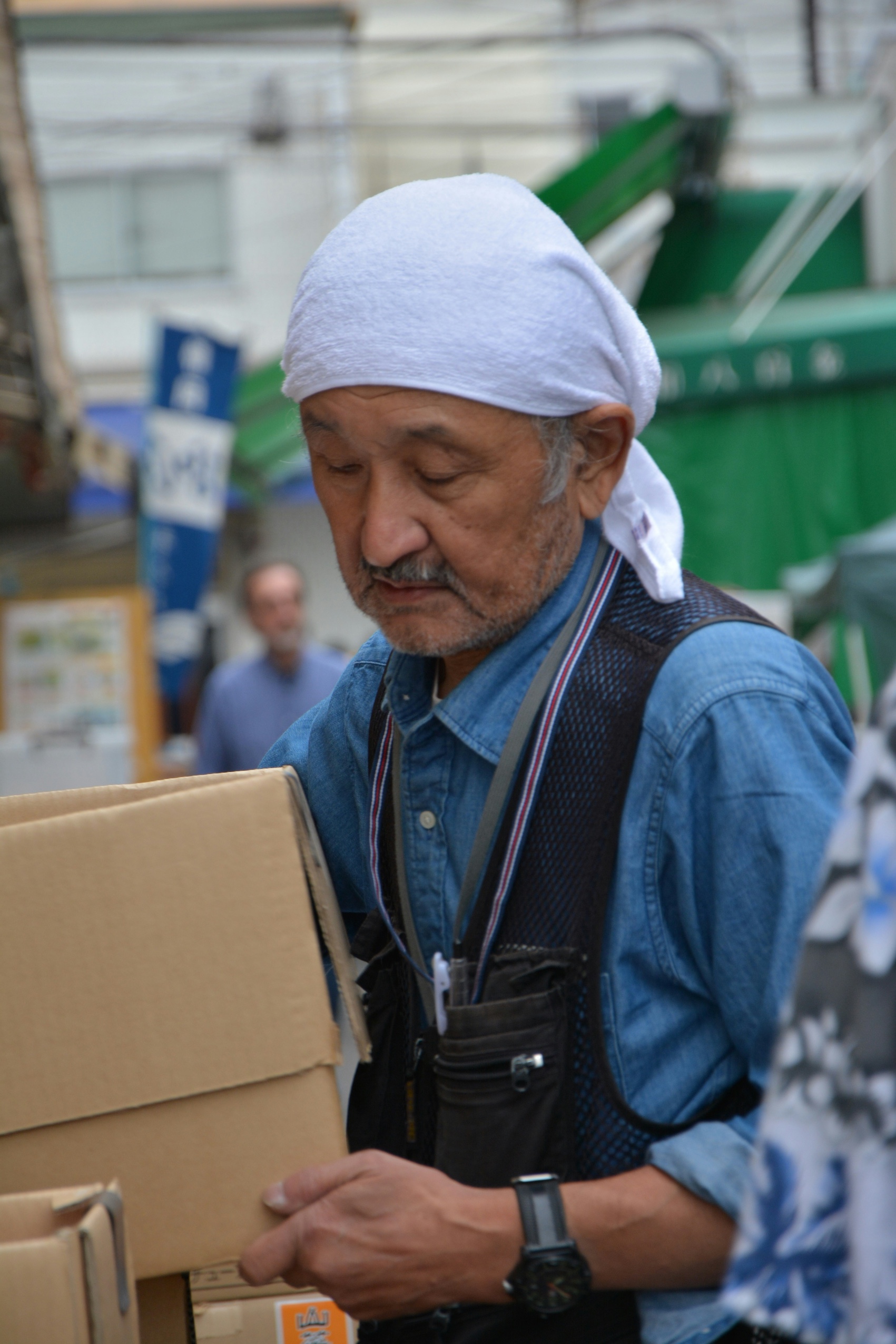 Older man packing boxes