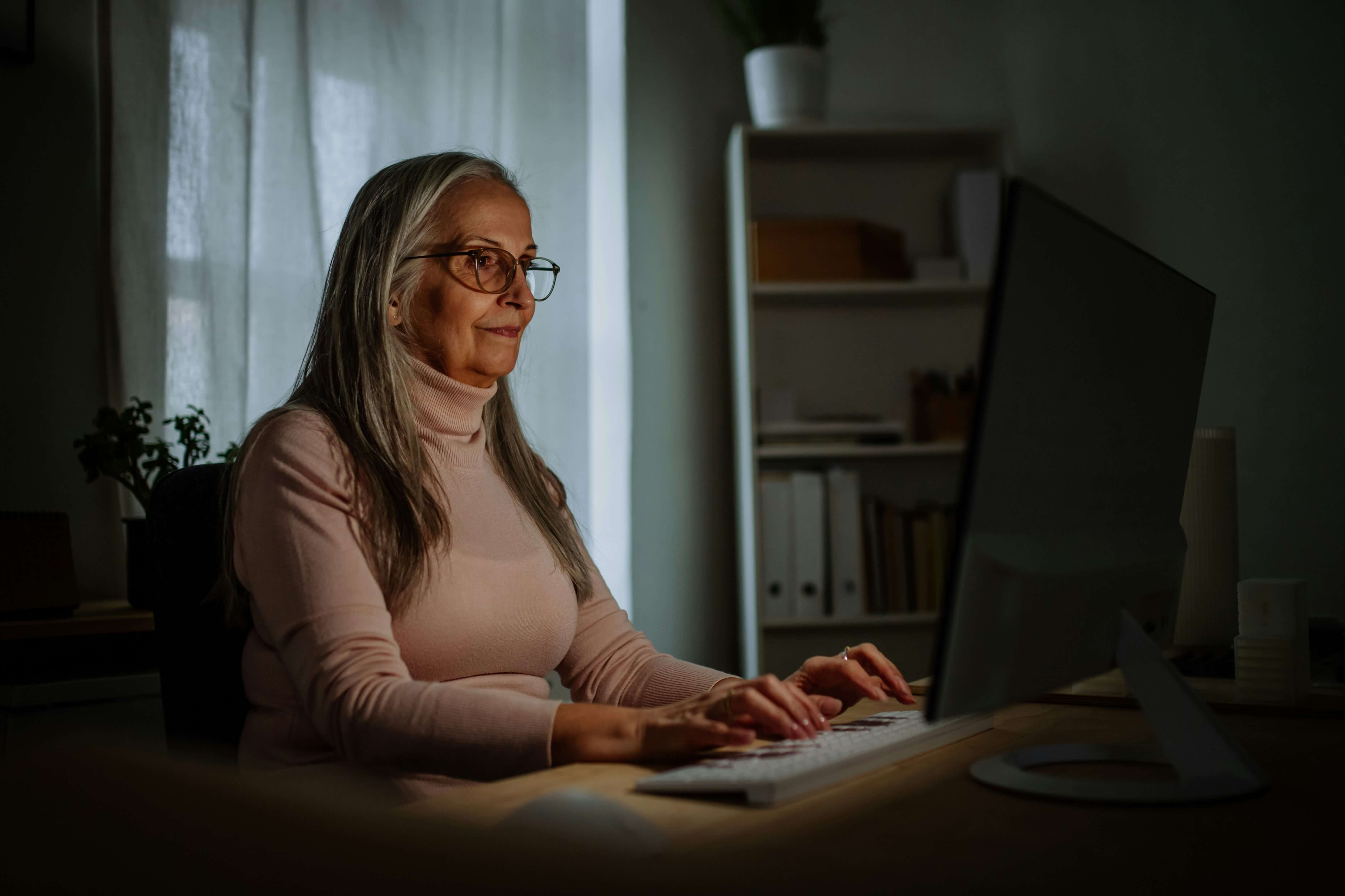 Older women at her computer at night