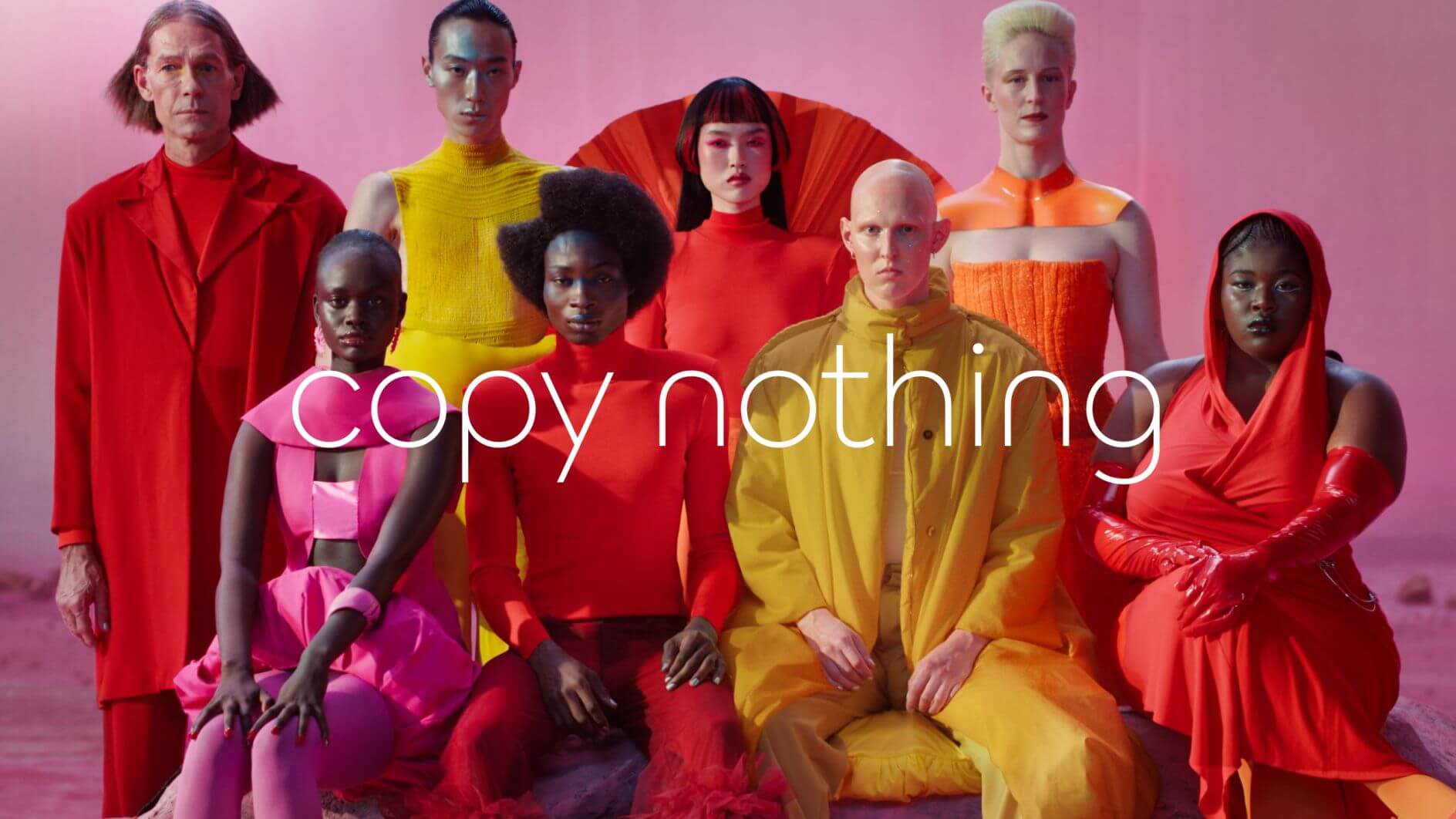 Jaguar ad showing lots of different people looking ta the camera with vwery colourfull clothes.