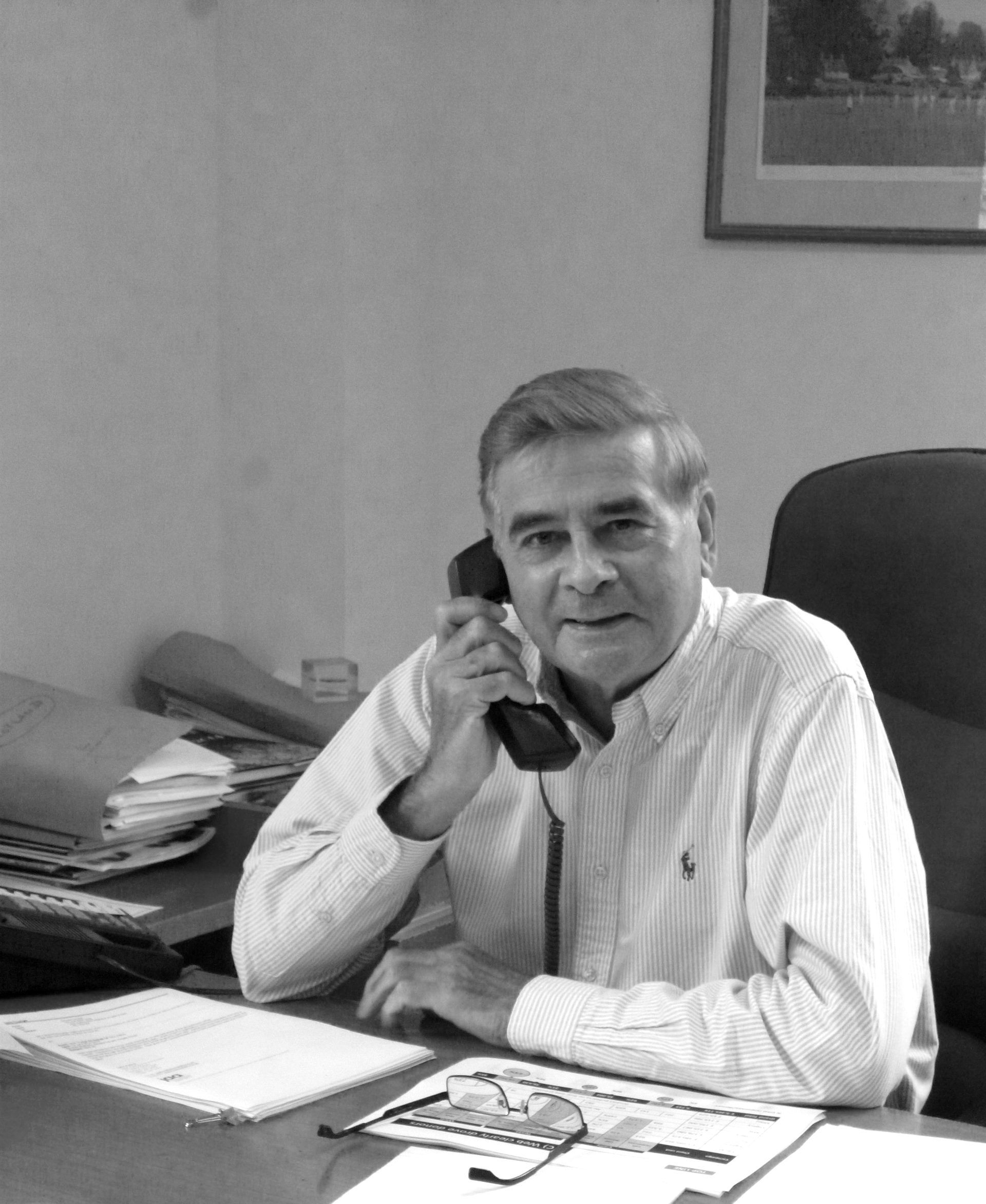 John Ayling sitting at the same desk that he sits in now but much younger.