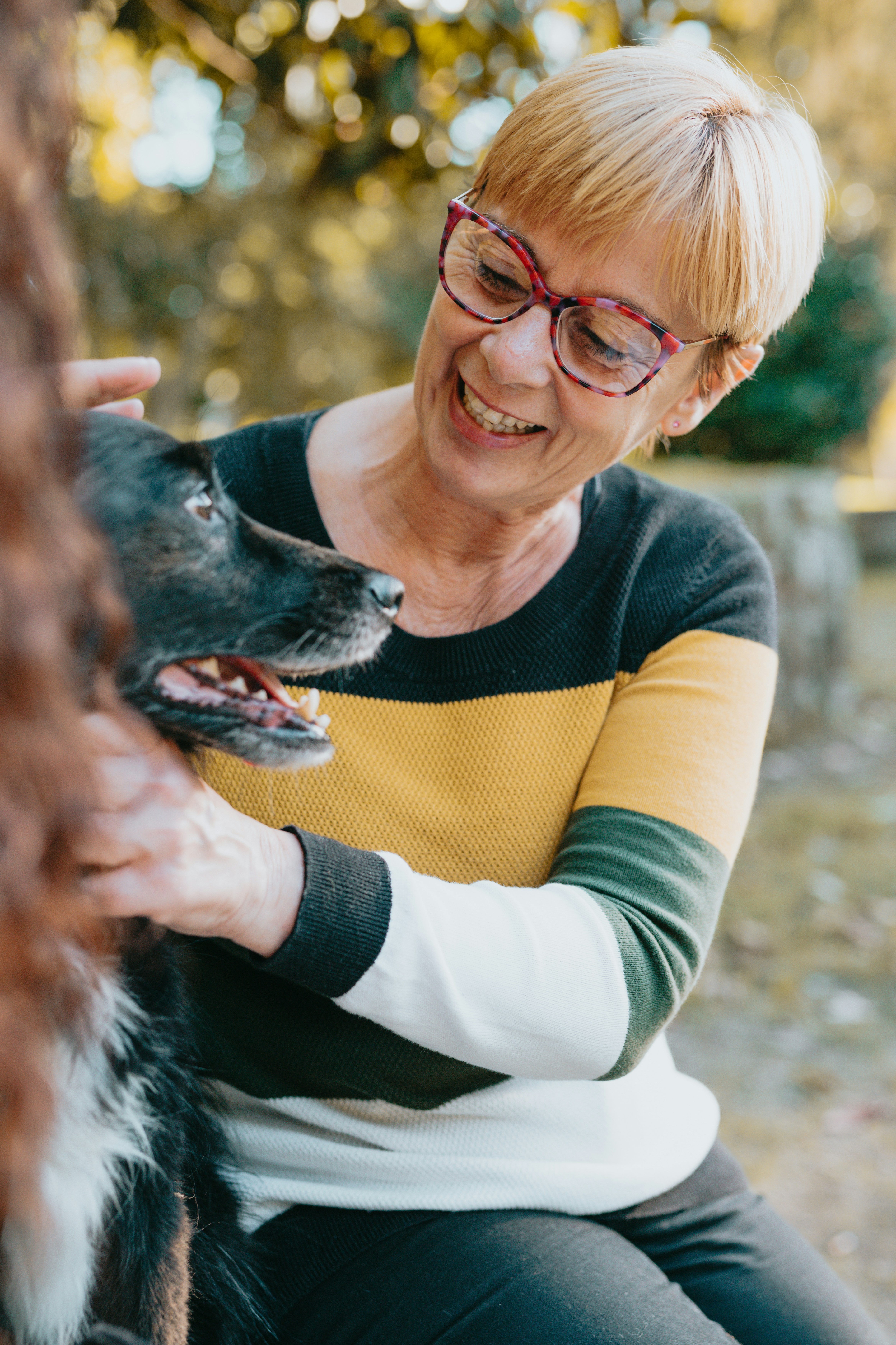 Woman in glasses smiling at her dog
