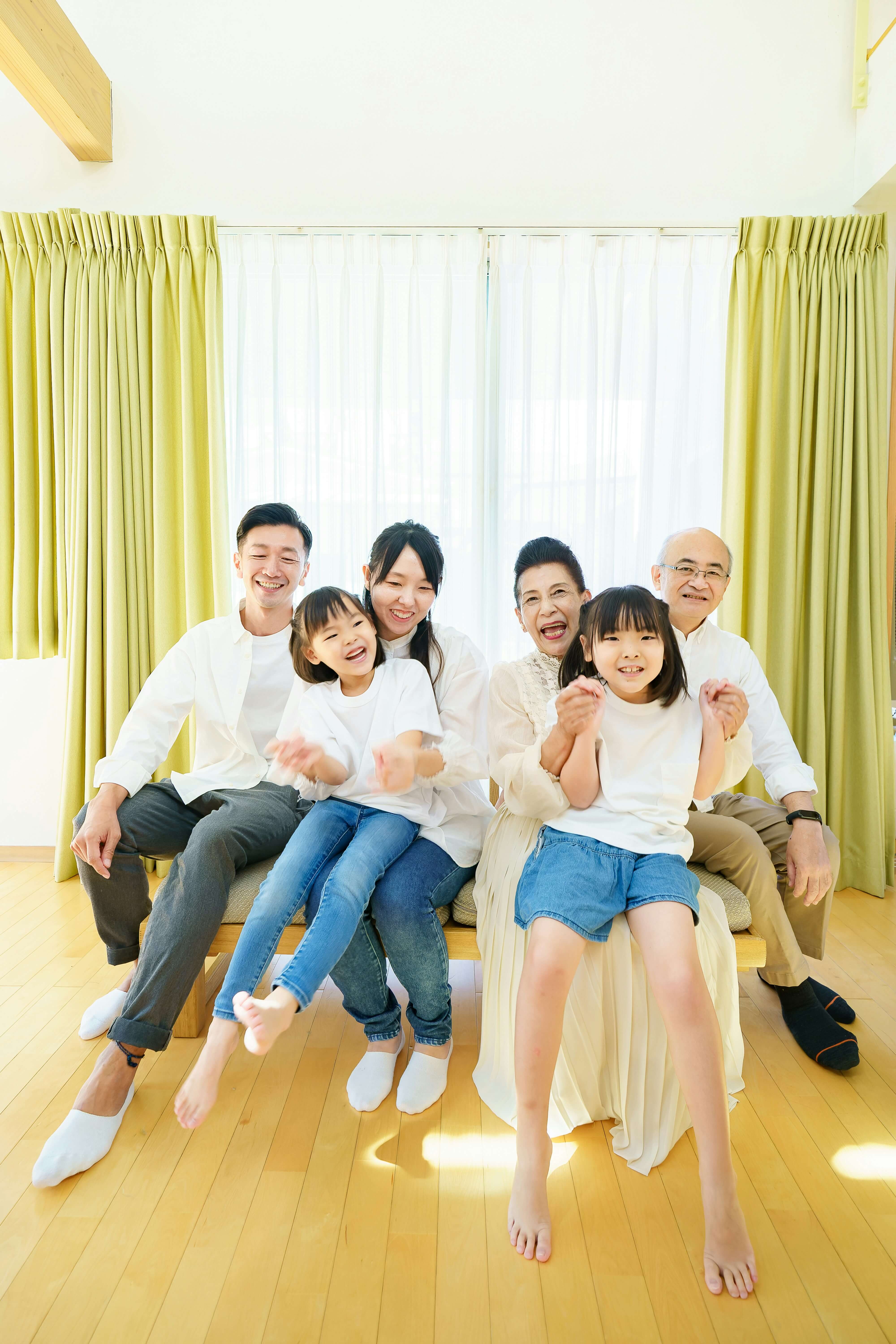 3 generations of family looking happy ion their home