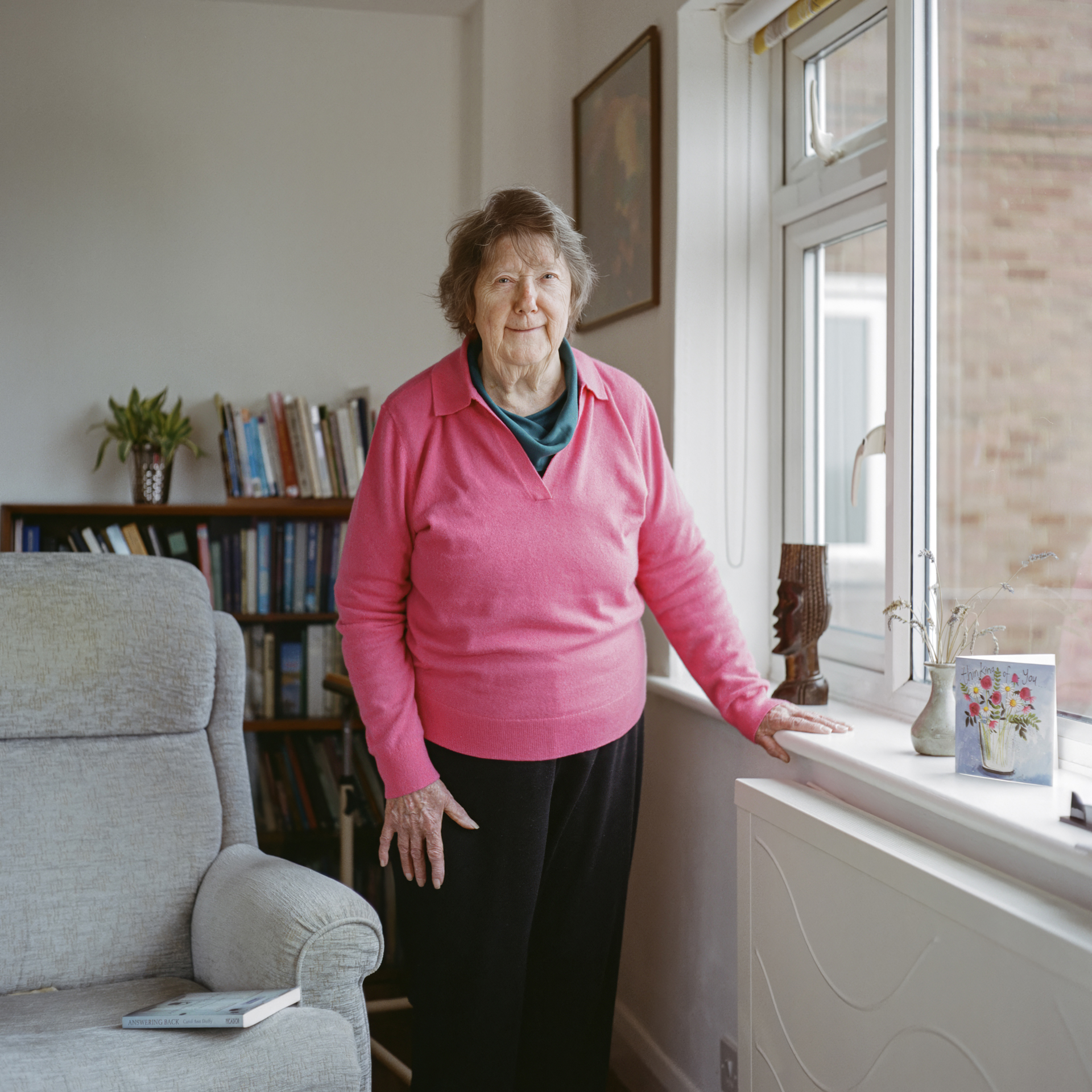 Christine standing by her window
