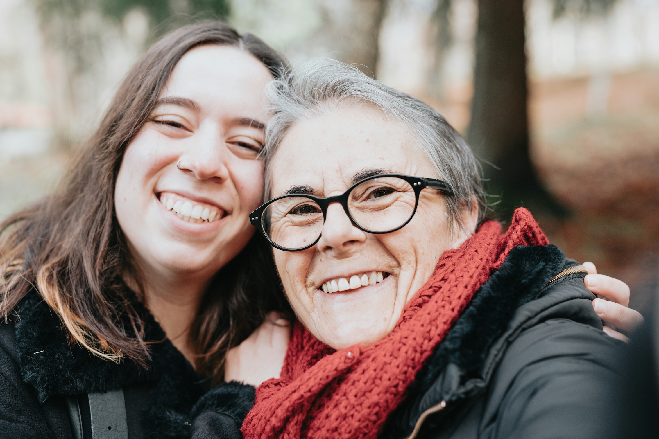 An older woman and younger women smiling at the camera