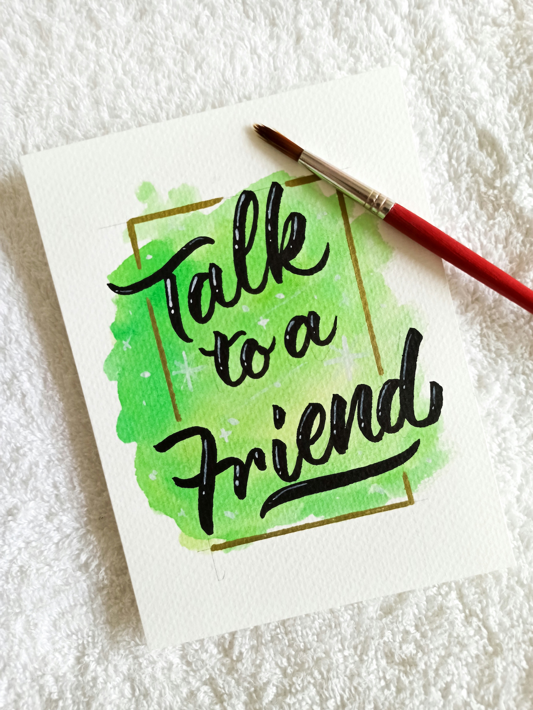 A paintbrush and water colour reading Talk to a Friend