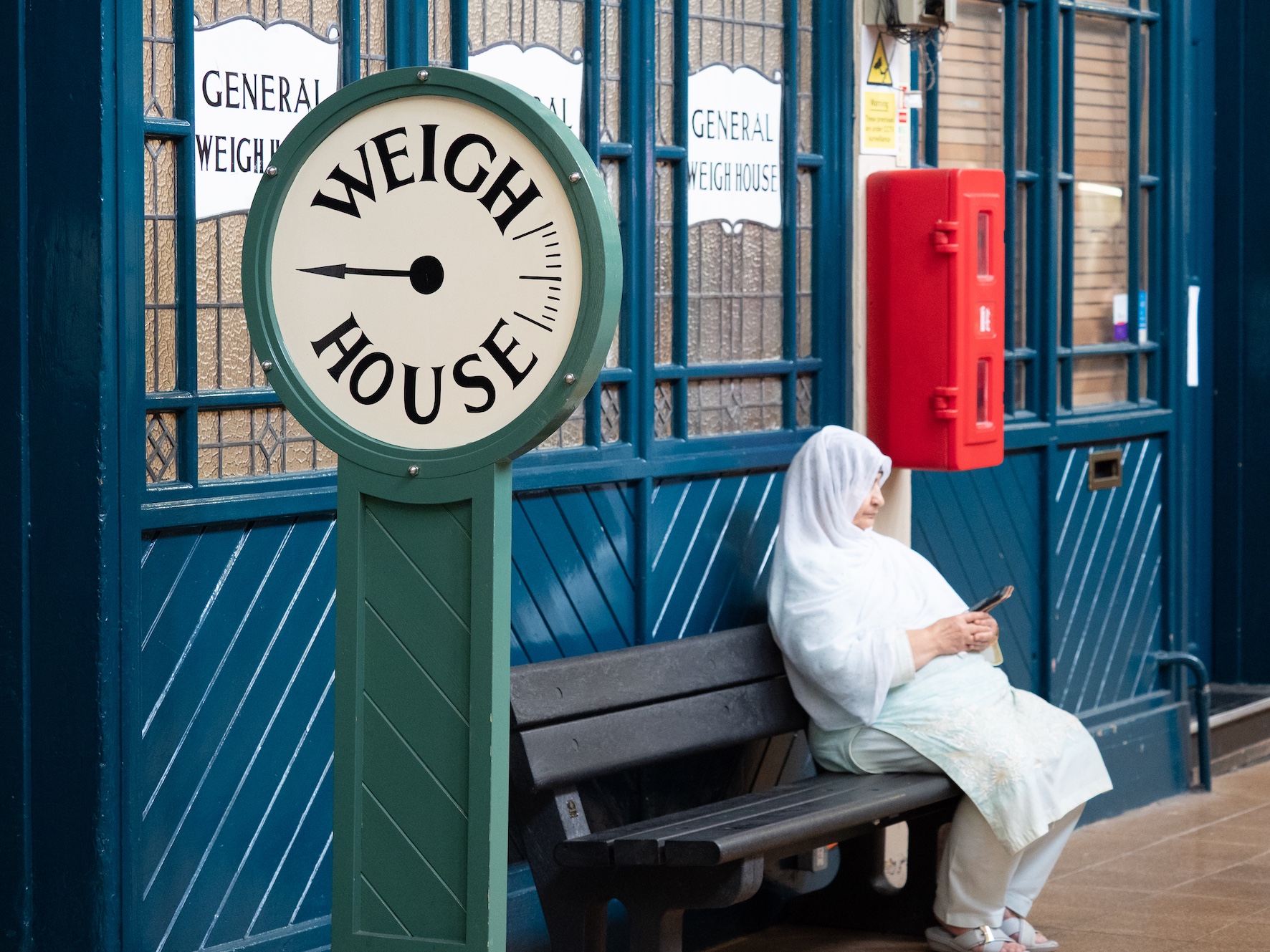 A pregnant woman taking a rest in a Slow Shopping event held in Grainger Market, Newcastle, UK