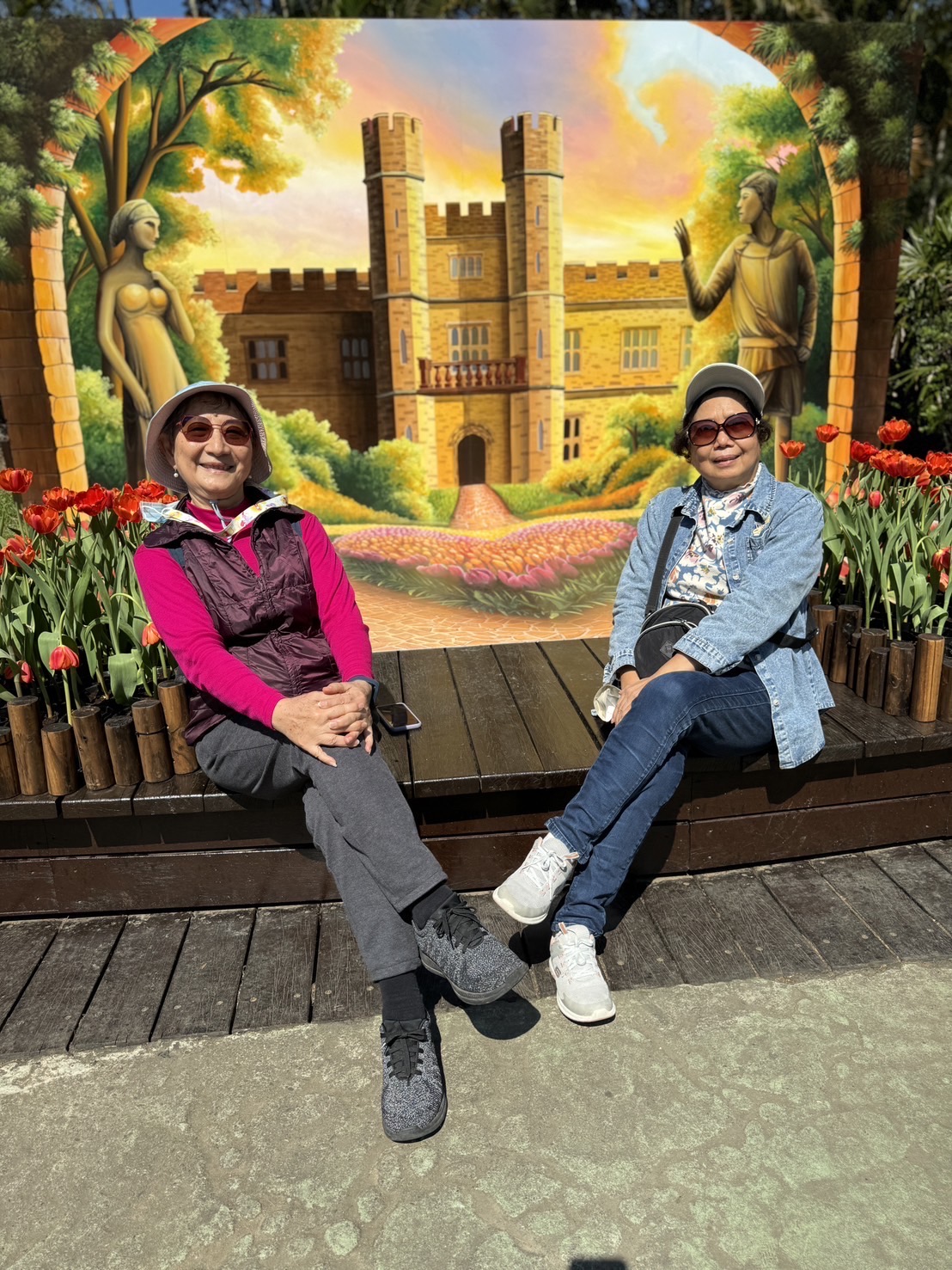 Mrs Chi sitting on a seat with a friend