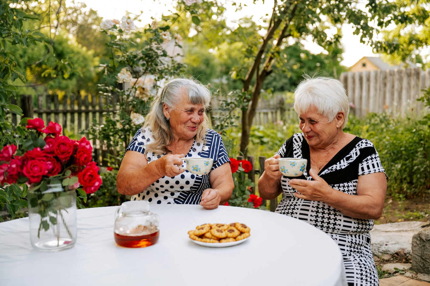 Two women having tea outside in the garden