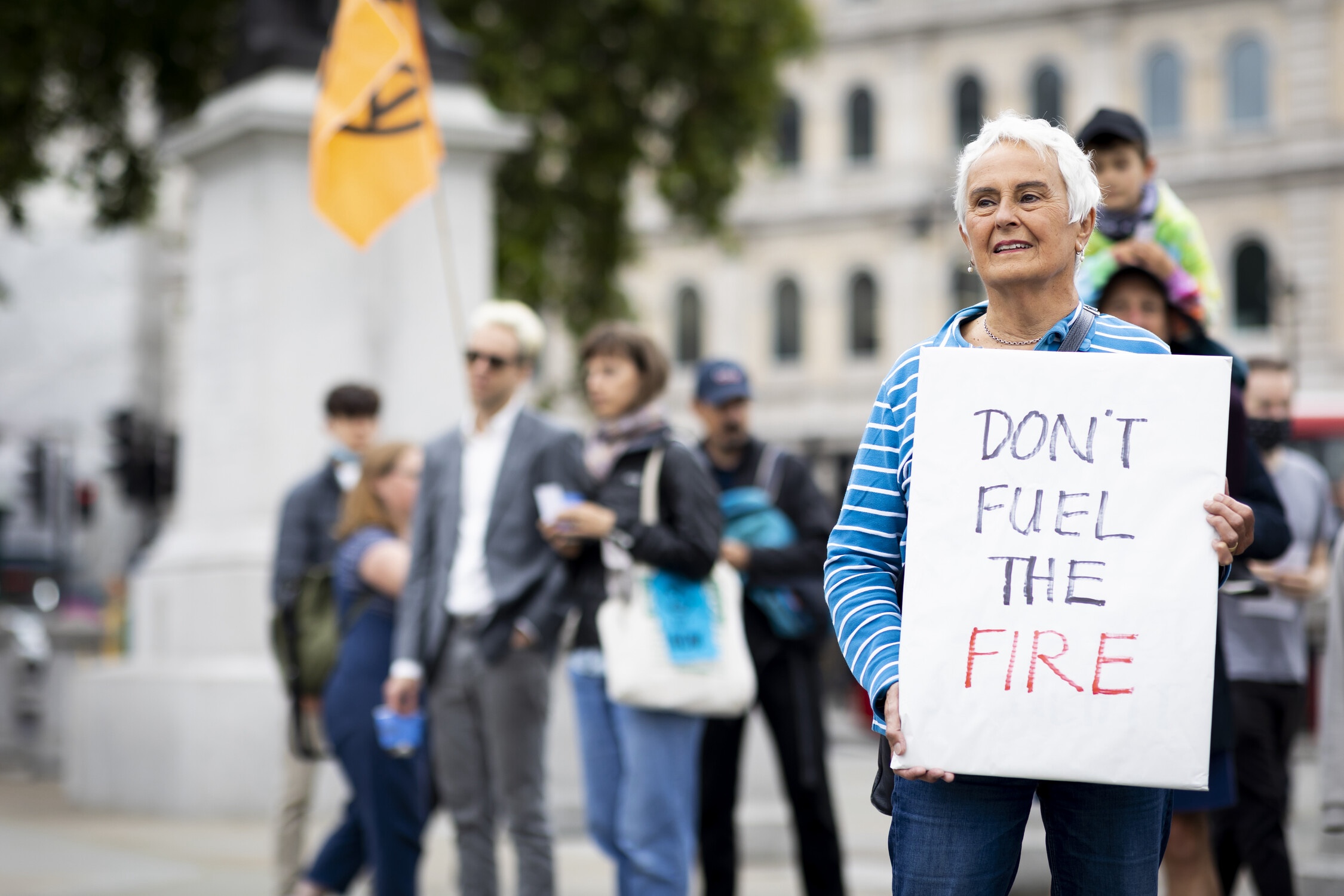 Older woman protesting against fossil fuel companies